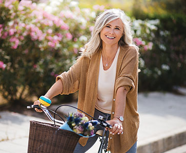 Woman riding bicycle. Links to Gifts of Real Estate